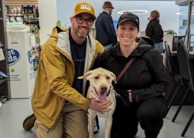 Man and woman adopting a yellow labrador retriever