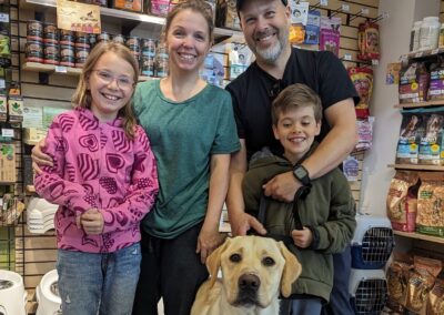 Family adopting a yellow labrador dog